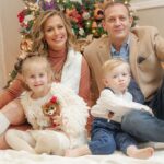Happy family against the backdrop of a Christmas tree.